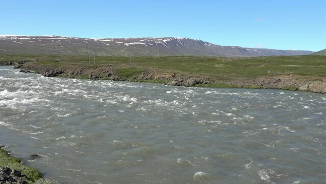 Fantastic landscape with flowing rivers and streams with rocks and grass in Iceland.