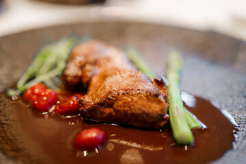 Closeup of freshly cooked meat with cherry tomatoes and celery served in plate at luxurious restaurant in hotel, luxury travel concept