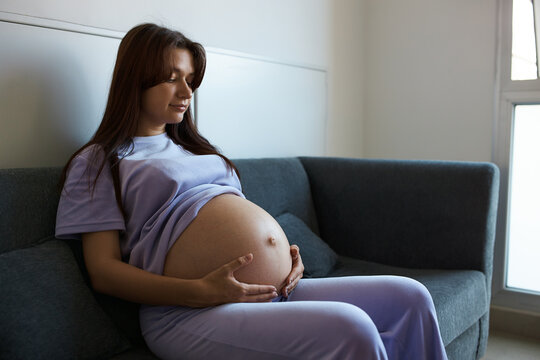 pregnant girl sitting on couch in spacious room, meeting room