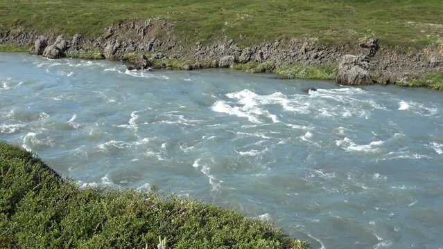 Fantastic landscape with flowing rivers and streams with rocks and grass in Iceland.