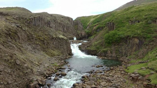 Fantastic landscape with flowing rivers and streams with rocks and grass in Iceland.