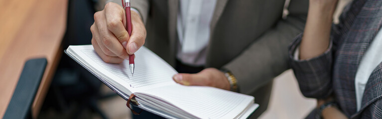 Close up of Businessman standing in office and making notes
