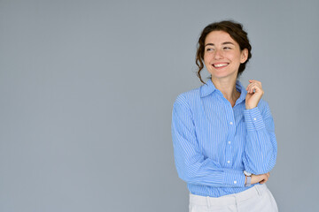 Happy young smiling professional business woman wearing blue shirt looking away interested in ads...