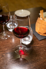 Dinner with glass of dry red wine in Italian osteria restaurant