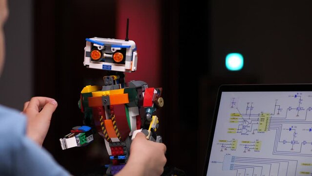 the boy completes the construction of the robot