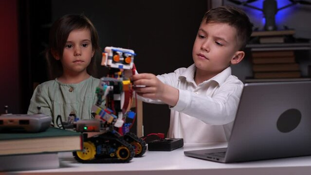 the boy and girl builds a robot and takes measurements with special equipment