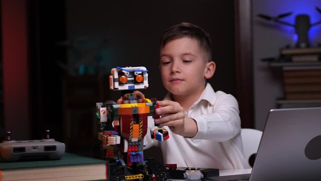 the boy completes the construction of the robot