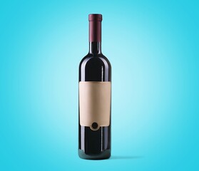 Red wine in glass bottle on pastel background.