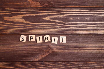 Word spirit, lettering on wooden background