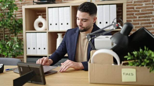 Young arab man business worker unemployed looking photography at office