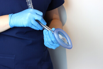 Laryngeal mask airway (LMA) in a health care professional wearing surgical gloves and surgical...