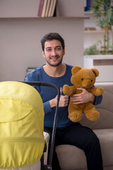 Young male contractor looking after baby at home