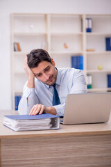 Obraz premium Young male employee working in the office