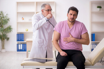 Young male patient visiting old male doctor
