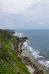 Fototapeta na wymiar 沖縄県伊江島の湧出（わじー）の崖から見える海と青空の風景 