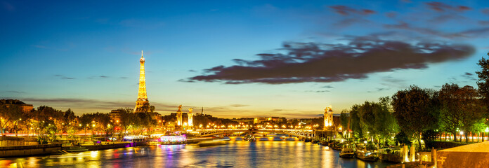 Seine river skyline view of Paris at sunset with Eiffel Tower in the background