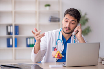 Young male doctor in telemedicine concept