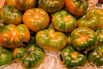 Pile of various heritage tomatoes at the farmers market