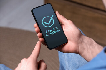 Man successfully made payment using online banking application on smartphone indoors, closeup
