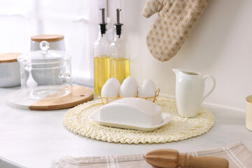 Set of different utensils and eggs on countertop in kitchen
