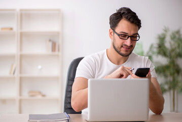 Young male employee working in the office