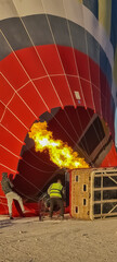 Hot air balloon inflating. Bright colors and clear blue skies. 