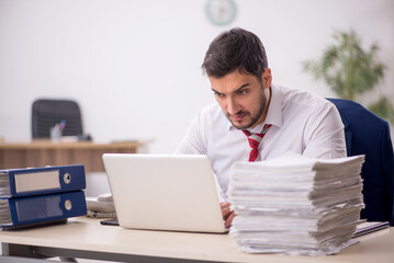 Young male employee working in the office