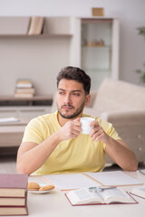 Young male student studying at home