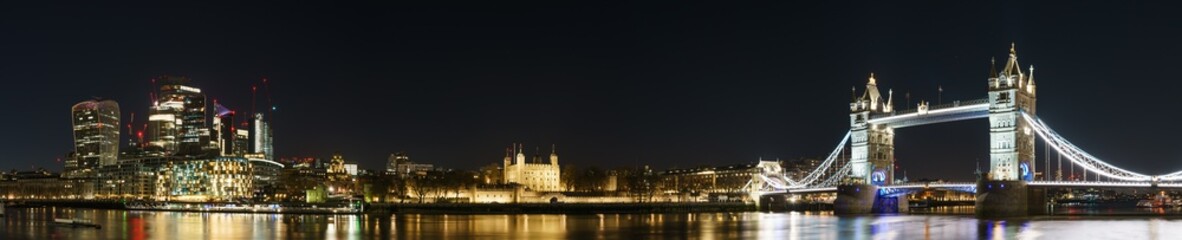 Fototapeta na wymiar Landmarks of London panorama at night including Financial district, Tower of London and Tower Bridge