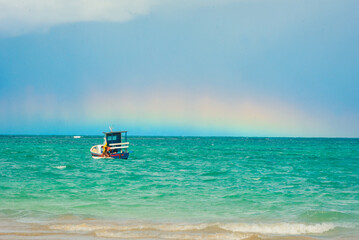 Boat on the sea with a rainbow in the background