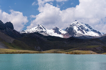 Nevado de Ausangate, Cuzco, Peru, Photo of the snow-capped mountain Ausangate at a beautiful day with a blue sky, with alpacas and puddles of water.