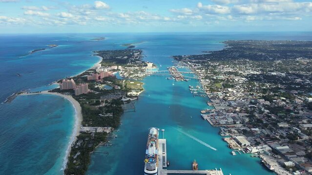 Beautiful cinematic aerial view of the Bahamas - Nassau city - cruise ship port, luxury hotels, buildings, and turquoise water oceans 
