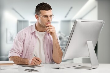 Cheerful male working on computer at home.