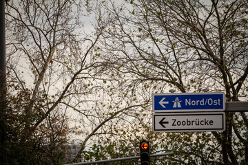 Fototapeta premium Selective blur on a german roadsign in Cologne, Germany, indicating directions to the autobahn motorway with direction Nord Ost (NorthEast) and local road to Cologne district of Zoobrucke.