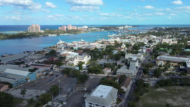 Beautiful cinematic aerial view of the Bahamas - Nassau city - cruise ship port, luxury hotels, buildings, and turquoise water oceans 