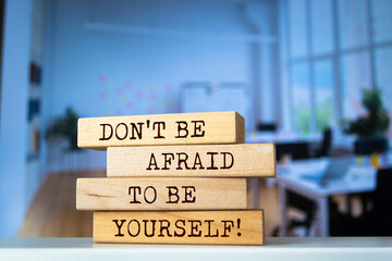 Wooden blocks with words 'Don't Be Afraid to be Yourself'.