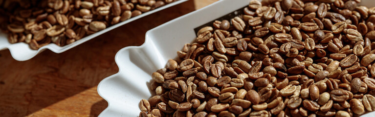 Bowls of roasted coffee beans on table