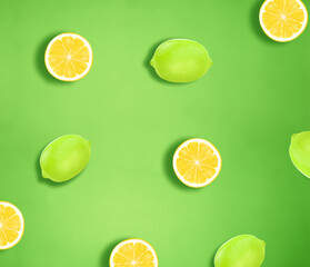Yellow and green lemon slices isolated on green background
