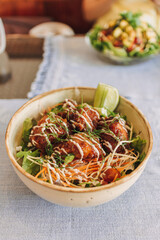 Japanese teriyaki rice with topping sauce served in a bowl.
