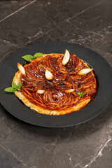 Delicious apple Tarte Tatin with sweet red apple, caramel, and puff pastry