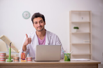 Young male dentist working in the clinic