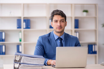Young male employee working in the office