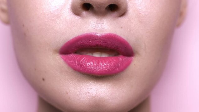 Sensual woman close her lips. Closeup view of sexy young model face with evening makeup and pink lipstick