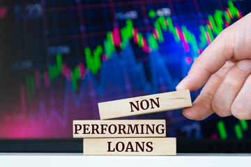 Wooden blocks with words 'NON PERFORMING LOANS'. Business concept