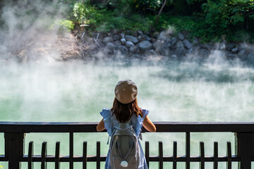 Young woman traveler looking at Hot spring pond at Xinbeitou thermal valley in Taiwan - obrazy, fototapety, plakaty