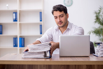 Young male employee working in the office