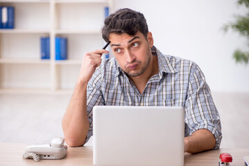 Young male employee working in the office