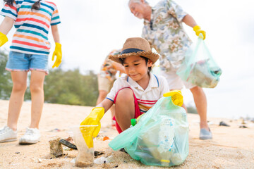 Group of Volunteers multi-Generation family picking up plastic trash and garbage together at the beach on summer holiday vacation. Environmental conservation earth day and waste pollution concept.