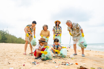 Group of Volunteers multi-Generation family picking up plastic trash and garbage together at the...