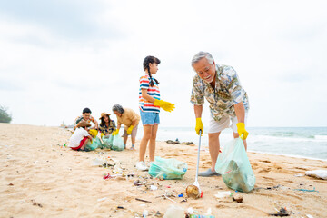 Group of Volunteers multi-Generation family picking up plastic trash and garbage together at the...